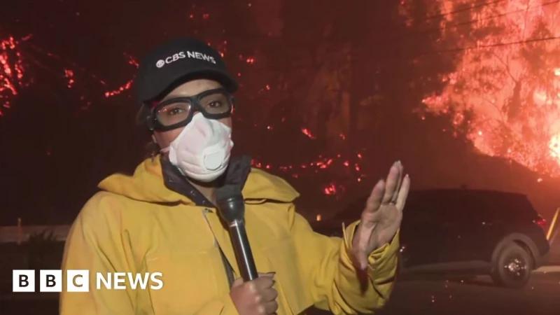 Watch: Ferocious LA fire burns behind CBS reporter